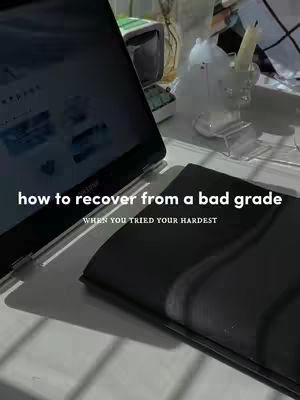 The cover image shows a laptop, a closed notebook, and a small object on a white surface. Text overlays read "how to recover from a bad grade" over "WHEN YOU TRIED YOUR HARDEST."