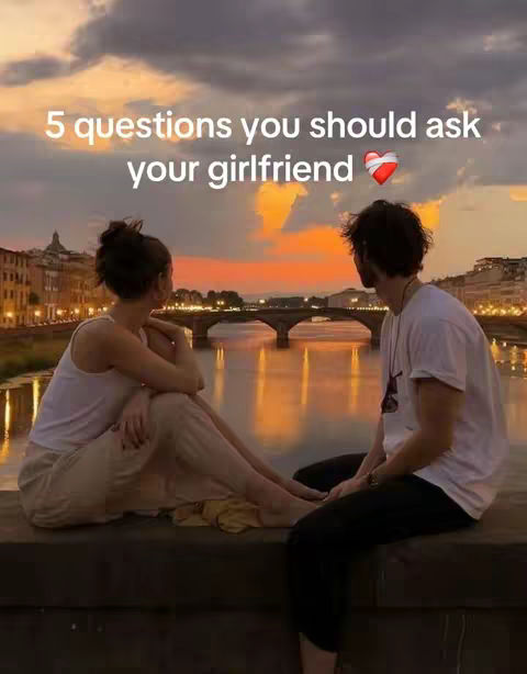 The cover image shows a couple sitting on a stone ledge, with their backs to the camera, overlooking a body of water and a cityscape. The sky is colorful with sunset hues and there is text overlaid at the top.