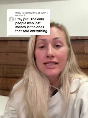 A woman with long blonde hair is centered in the frame, appearing to speak directly to the viewer. Behind her, a wooden panelled wall provides a neutral background. At the top, a white box displays text in black, presenting a comment. The overall composition centers on the woman's direct gaze.