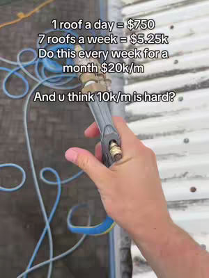A hand holding a pressure washer nozzle, spraying water. In the background are roof tiles and blue hoses. Text overlays detail potential earnings.