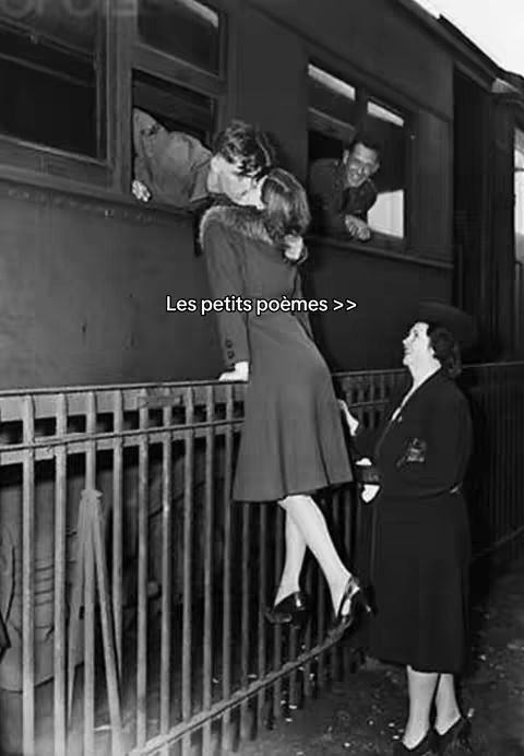 A black and white photo from the past shows a couple kissing through a train window. The woman is standing with one leg up, leaning precariously off the edge of the train, while a man from the window leans out, kissing her. In the background, another man looks out from another window. There is someone standing on the platform, watching them. The shot is framed in a way to capture a moment of romantic intimacy and an emotional farewell. Text is added as a hook.