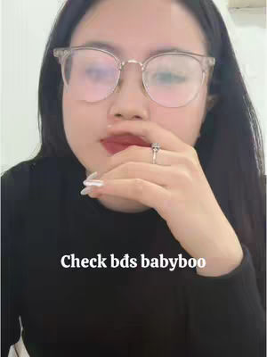 A close-up shot of a woman's face. She is wearing eyeglasses, and her hand is raised near her face. White text is overlaid at the bottom.