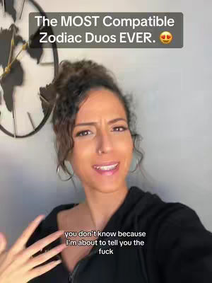 A woman with dark hair, wearing a black top, is centered. Overlay text at the top says 'The MOST Compatible Zodiac Duos EVER.' Below her, text reads 'you don't know because I'm about to tell you the fuck'. A decorative clock is visible in the background.