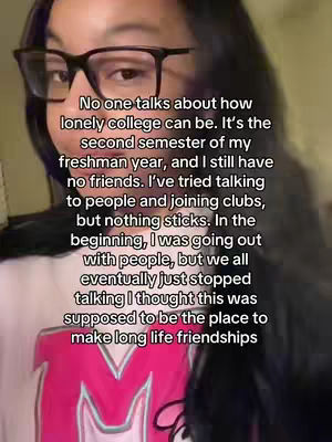 A selfie-style video cover image featuring a young woman with glasses. She is positioned from the chest up, against a blurred background. Text overlays the image, with conversational text describing feelings of loneliness in college.