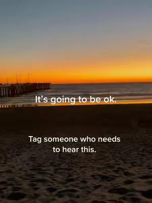 A serene beach scene at sunset. The sky is ablaze with vibrant oranges and yellows, transitioning to blue near the top. Silhouettes of a pier and the ocean are visible, with the sand in the foreground. Text overlays are added onto the scene.
