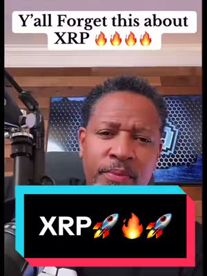 A man with short dark hair is in the center, looking towards the camera with a serious expression. Above him, a text overlay reads 'Y'all Forget this about XRP' in a white font, with fire emojis around it. Below, a teal and black bar declares 'XRP' in large white letters, flanked by rocket ship emojis and a fire emoji. The background includes a wooden wall and some studio equipment.