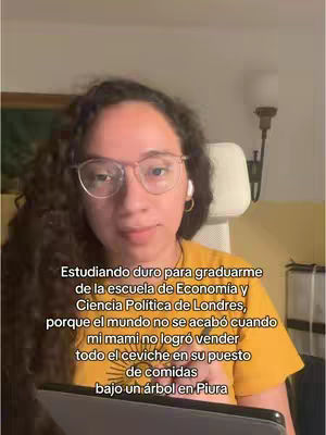 A woman with curly dark hair, wearing glasses and a yellow shirt, is looking at the camera. Text overlay is on the botton.