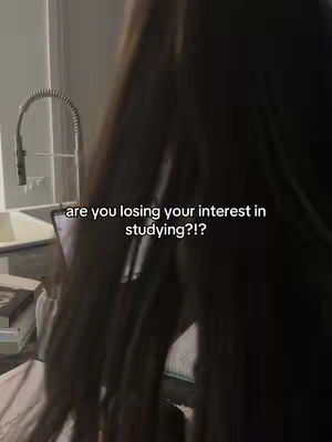 The cover image shows a person, presumably the creator, with a blurred view of the person's hair and part of the body, potentially on a bed or couch, with a laptop in front. Overlayed text asks, "are you losing your interest in studying?!?" in white, positioned below the upper third of the frame. The lighting is soft and likely indoor, with muted tones.