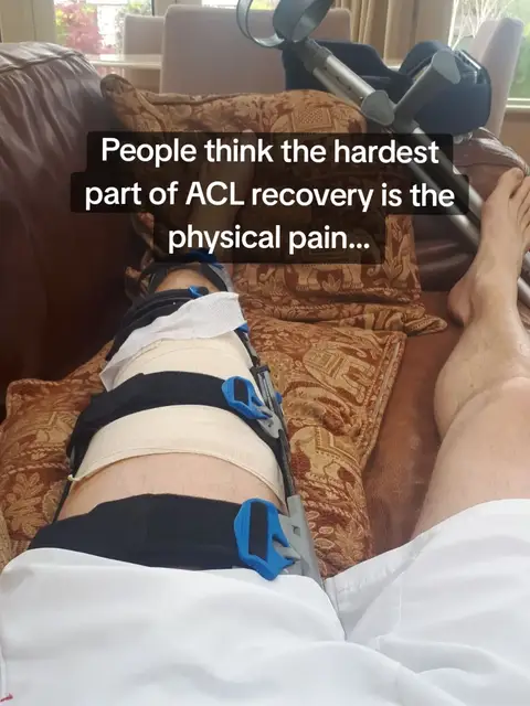 A person is lying on a couch with their leg elevated and braced, wearing shorts. The leg has a large brace on it, and crutches are resting on the couch. Text overlays the image.