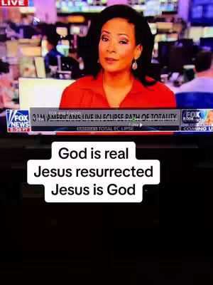 The image is of a woman in a red top speaking in a newsroom or studio setting. Behind her is a screen displaying various graphics and text. On the bottom of the frame, a white rectangular box contains the superimposed text "God is real Jesus resurrected Jesus is God". Above this, some text is partially visible, reading "3M AMERICANS LIVE IN ECLIPSE PATH OF TOTALITY". The FOX NEWS logo is visible in the top left corner.