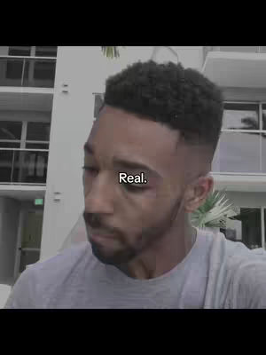 The cover image shows a man with a short haircut in front of a building. The text overlay on the image reads "Real."