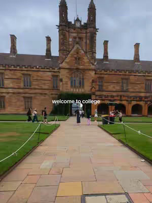 An eye-level shot showcases the University of Sydney's main building, an impressive sandstone structure. The building's facade is symmetrical, with a central entrance and tall, arched windows. People are seen casually walking in the courtyard. The sky is overcast.