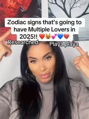 The cover image is a selfie of a woman with long dark hair and heavy eye makeup. She is wearing a gray turtleneck sweater. Above her head is a text box with the words "Zodiac signs that's going to have Multiple Lovers in 2025!!" with several emojis, including hearts, a cat, and a broken heart. The woman is pointing to the text. Behind her, there are hints of art on the wall.
