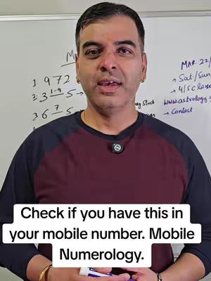 A man wearing a burgundy and navy blue shirt stands in front of a whiteboard with handwritten text. The man has short, dark hair and gold earrings. Text overlay states, "Check if you have this in your mobile number. Mobile Numerology."