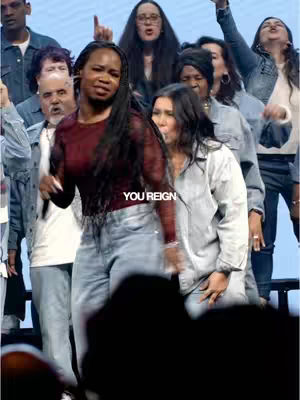 The cover image captures a dynamic moment from a worship service. A group of people is gathered, with a woman in the foreground wearing a burgundy top and jeans, singing and dancing. The composition is filled with a mix of people, some with raised hands, conveying an atmosphere of religious expression and celebration.