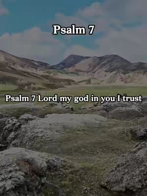 The image is a vertical frame featuring a nature scene with text overlays. The lower half of the frame is dominated by a rough, rocky foreground, suggesting a mountainous environment. Above this lie gentle, rolling hills of pale green, leading towards a backdrop of deeper mountains that fade into the distance. The sky is a mix of blue and white, with clouds partially obscuring the top of the scene. The text overlays are clear white, the upper one saying "Psalm 7" and a lower one which says "Psalm 7 Lord my god in you I trust". The text is placed near the top and middle of the frame respectively, making sure it's visible and understandable.