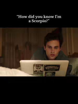 The image features a man looking at a laptop. The text overlayed on top says, "How did you know I'm a Scorpio?"
