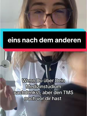 A selfie-style image featuring a young woman wearing glasses and a white lab coat, holding a stethoscope. Text overlays are present, and the overall composition focuses on the upper body. The background is a light-colored wall.