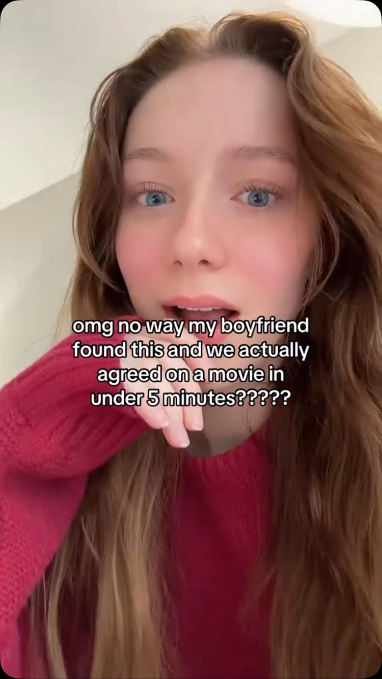 A light-skinned young woman with long auburn hair and light blue eyes is framed in a close-up shot. She's wearing a red knit sweater and appears to be looking directly at the camera with an animated expression. Overlaying the image is the text in a white font, describing a relatable situation.
