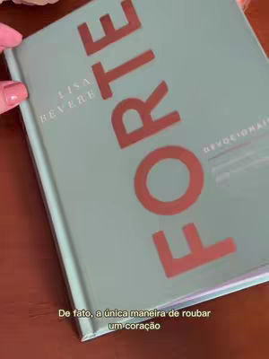 The cover of a book titled "FORTE" is open on a surface with a woman's hand holding it, the title text is in a bold, red color that contrasts with the light green book cover. The book is slightly angled, and the top of the book is visible with the title.