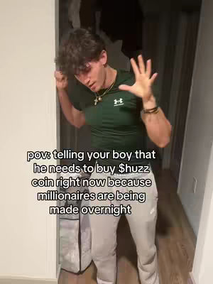 A young man stands in a doorway, leaning against the frame with one hand raised and the other on his chest. Text overlayed explains "pov: telling your boy that he needs to buy $huzz coin right now because millionaires are being made overnight."