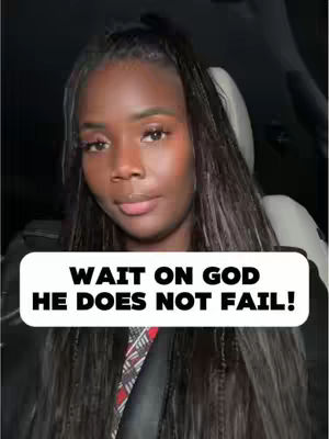 A woman of color in her car, looking at the camera with a neutral expression. She has long, dark hair styled in braids across her forehead, and a black top. A text box with white background and black bold letters is overlaid near the bottom of the image.