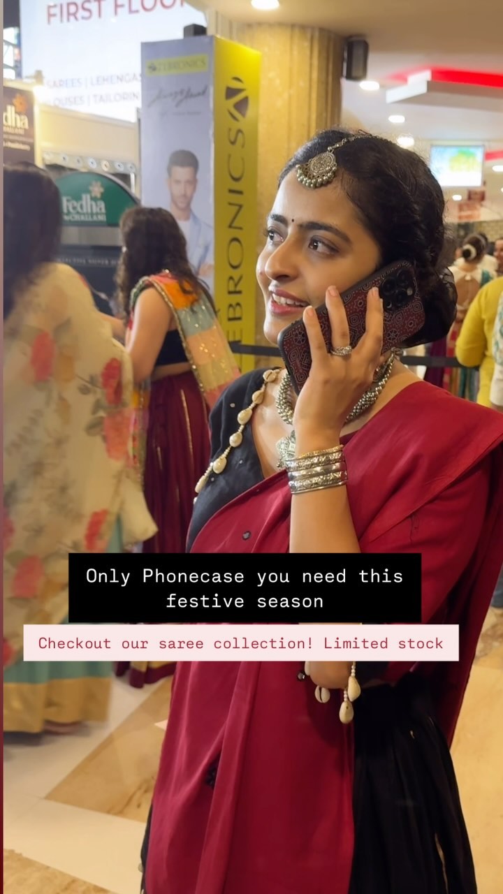 A woman in a saree is on a call in a shopping mall. Text overlay says the phone case is the only thing needed for the festive season and invites to check out their saree collection. The background includes other shoppers and store signage.
