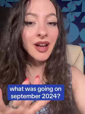 The cover image features a close-up of a woman's face. She has long, dark wavy hair. She is speaking, and a blue bar with white text is overlaid on the bottom of the screen. In the background, a patterned wallpaper with teal shapes can be seen.