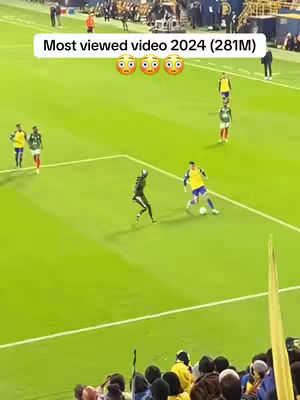 The cover image captures a live soccer match featuring a wide shot revealing a green field. Players in contrasting yellow and green uniforms are visible, with a player in black strategically placed in the center to intercept the ball. The upper section presents the text overlayed hook. The lower portion includes a crowd watching the game.