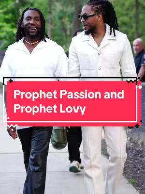 Two men walking side by side on a sidewalk, trees in the background. There is a red bar across the bottom that says "Prophet Passion and Prophet Lovy".