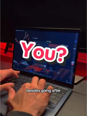 A person is using a laptop with a trading software interface open. The screen displays charts and graphs. Overlayed on the screen is large text that says 'You?'. The user's hands are visible on the keyboard, and the overall image suggests a financial or trading theme.