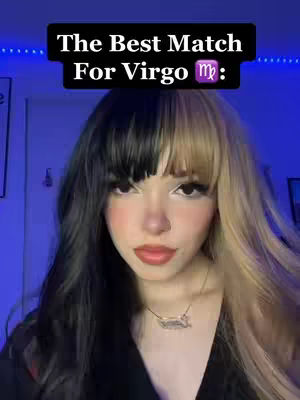 A woman with half black and half blonde hair is centered in the frame. Above her, a black bar contains white text that reads, "The Best Match For Virgo". Below the text is a Virgo symbol rendered in purple. The woman has a necklace and a light colored background around her. The image is well-lit, highlighting the subject's face.