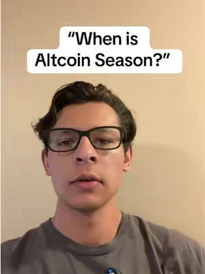 A man wearing glasses looks at the camera with a neutral expression. Above him is a white banner with black text: "When is Altcoin Season?". The background is a plain, warm-toned wall.