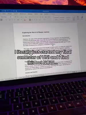 A laptop screen displaying a document titled 'Exploring the Marvel of Human Anatomy' is the central focus. The keyboard and a portion of the laptop's base are visible in the foreground. Overlaid on the screen is the text: 'I literally just started my final semester of UNI and i find this out NOW...'. The background shows a glimpse of a room with warm lighting.