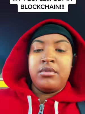 A selfie-style shot featuring a woman with a black head covering and a red hoodie. The woman is looking towards the camera. Above her head is a white text box with the words "MY PEOPLE!!!...GET IN BLOCKCHAIN!!!".