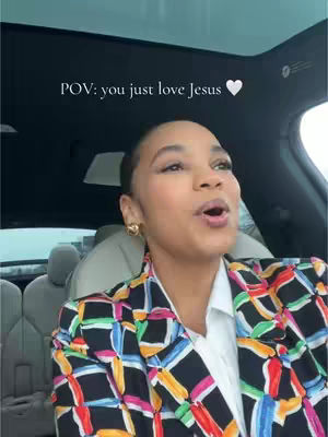 A woman with short, dark hair is shown inside a car, looking slightly to her left with her mouth open as if she's speaking. She's wearing a patterned blazer over a white shirt. The background includes the car's interior, with a dark ceiling and the suggestion of outdoor light. The text overlay says, "POV: you just love Jesus 🤍".