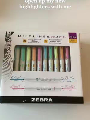 The cover image shows a white box of Mildliner highlighters with the brand name Zebra. Inside the box, there's a grid of pastel-colored markers. Above there is the text 'open up my new highlighters with me'.