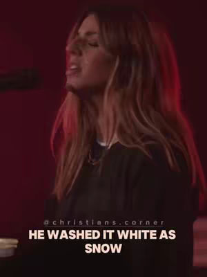 A woman with long blonde hair sings in front of a dark red background. The hook is a white text overlay reading, "HE WASHED IT WHITE AS SNOW."