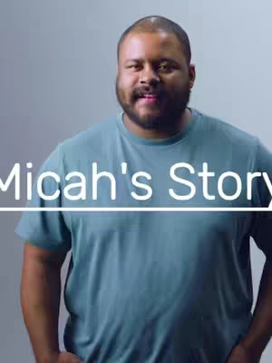 The cover image features a man with a beard in a teal t-shirt against a pale grey background. Overlaid on the image is the text, 'Micah's Story,' in white. The man is centered in the frame, looking towards the camera.