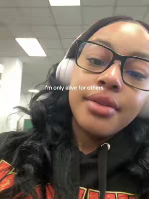 The cover image is a selfie of a person wearing glasses and headphones. Text overlayed on the image reads: "I'm only alive for others."