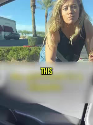 A woman in a black top and jeans leans over the front of a vehicle, with a bright sky and palm trees in the background. The text overlay reads 'THIS'.