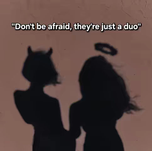 The image features a silhouette against a soft, blurred background. Two figures are visible: one with horns, suggesting a devilish character, and another with an angel's halo above their head. The silhouettes are dark and contrasting against the lighter backdrop, creating a sense of duality, possibly representing opposing forces or internal conflict.