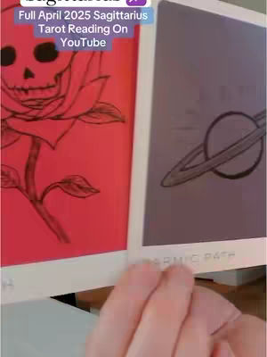 The cover image displays two tarot cards held in a hand. The left card features a detailed black-ink illustration of a skull and a rose on a red background. The other card, on the right, contains a drawing of a ringed planet against a purple backdrop. The background is neutral in appearance against the red and purple tarot cards. A hand is holding the cards.