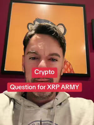 A man in a grey hoodie is centered in the frame, slightly angled toward the viewer. Behind him is a framed picture with an orange background and a monkey-like graphic. Two red rectangles with white text overlay the man's face, one reading "Crypto" and the other "Question for XRP ARMY". The background is a dark maroon color.