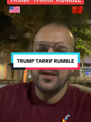 A man with a beard and glasses is the central figure, set against a background of what appears to be an outdoor or dusk setting. The man is wearing a maroon shirt. The image has a text overlay featuring the words 'TRUMP TARRIF RUMBLE'. The flags of the United States and China are added above the text.