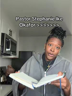 A woman with dark hair pulled up in a bun is looking at the camera while holding up a notebook. Text overlays the image.