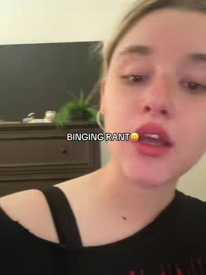 A selfie-style shot featuring a woman with blonde hair and fair skin. She has full, red lips and is wearing a black top. The text overlay "BINGING RANT" with a smiling face emoji is placed at the bottom.