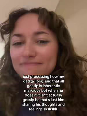 A selfie-style video with a woman's face taking up the majority of the frame. She has long, wavy brown hair with bangs. Her expression is neutral, with her lips slightly pursed. Text overlayed on the image provides context about the video's content.