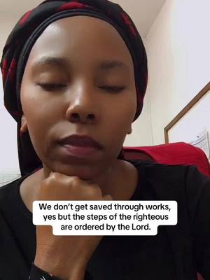 A close-up shot of a woman with dark skin wearing a black head covering and a black top. She has her eyes closed and her head resting on her hand, with a thought bubble containing text overlaid on the image.