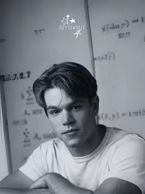 A black and white headshot featuring a man looking towards the camera with a serious expression. He has neatly styled hair and is wearing a white t-shirt. The background features abstract handwriting and equations on a white board. Above on the top left it is written "BETTERSELF" with a symbol.